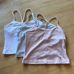 Three cropped lululemon Power Y Tanks